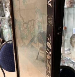 A Chinese mother-of-pearl inlaid wooden screen with silk paintings, 19th C.