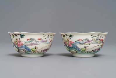 A pair of Chinese famille rose cups and saucers with figures in a landscape, Yongzheng