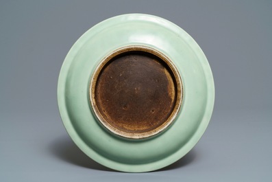 A Chinese celadon-ground dish with blue and white landscape medallions, 18/19th C.