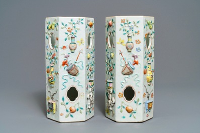 A pair of Chinese famille rose reticulated hat stands with applied designs, 19th C.