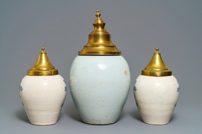Three Dutch Delft blue and white tobacco jars with brass covers, 18th C.