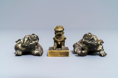 A pair of Chinese bronze 'lion' scroll weights and a seal, Ming and 18th C.