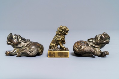 A pair of Chinese bronze 'lion' scroll weights and a seal, Ming and 18th C.