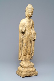 A Chinese carved stone figure of a standing Buddha, Ming or later