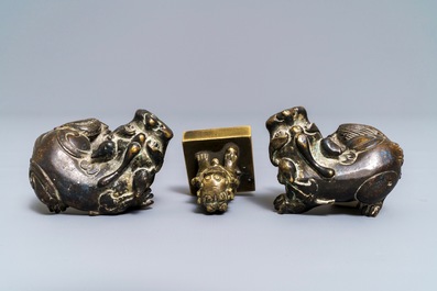 A pair of Chinese bronze 'lion' scroll weights and a seal, Ming and 18th C.