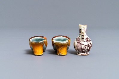 A pair of Dutch Delft polychrome slippers, a miniature jug and a fine lid, 18th C.
