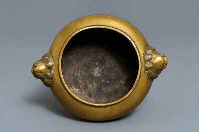 A Chinese bronze tripod censer with lion head handles, 19/20th C.