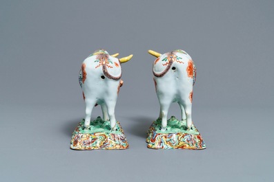A pair of polychrome petit feu and gilded Dutch Delft models of cows, 1st half 18th C.