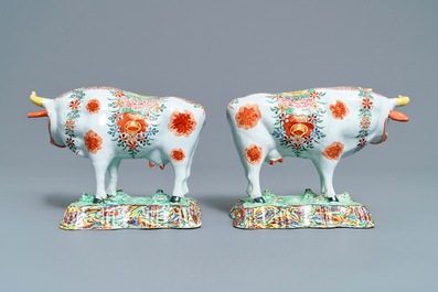 A pair of polychrome petit feu and gilded Dutch Delft models of cows, 1st half 18th C.