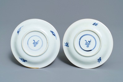 A pair of Chinese blue, white and underglaze red cups and saucers, Kangxi