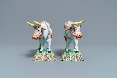 A pair of polychrome petit feu and gilded Dutch Delft models of cows, 1st half 18th C.