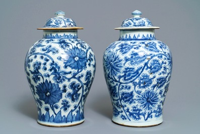 Two Chinese blue and white 'lotus scroll' vases and covers, Kangxi