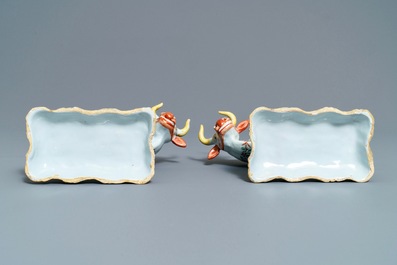 A pair of polychrome petit feu and gilded Dutch Delft models of cows, 1st half 18th C.