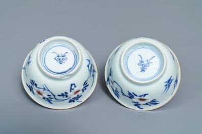 A pair of Chinese blue, white and underglaze red cups and saucers, Kangxi