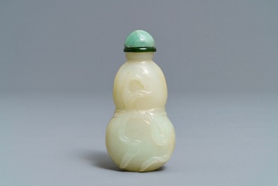 A Chinese pale celadon and russet jade double gourd snuff bottle, 19th C.