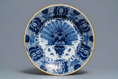 A Dutch Delft blue and white 'peacock's tail' dish and a pair of plates, 18th C.