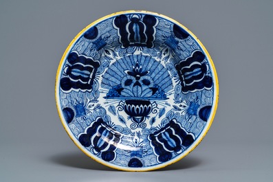 A Dutch Delft blue and white 'peacock's tail' dish and a pair of plates, 18th C.