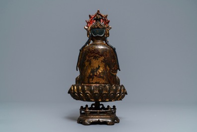 A Chinese gilt-lacquered bronze figure of Guanyin on a lotus throne, Ming