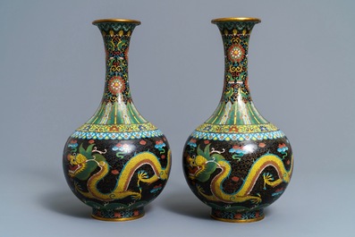 A pair of Chinese cloisonn&eacute; bottle vases, two silver saucers and a silver cup, 19/20th C.
