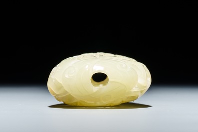 A reticulated Chinese celadon jade pendant and a lotus leaf with birds, 19/20th C.