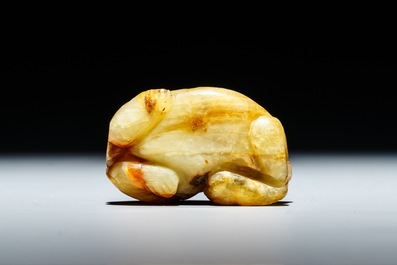 A Chinese celadon and russet jade carving of a tiger, Ming