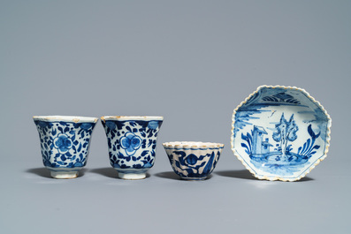 A pair of Dutch Delft blue and white plates, three cups and a saucer, 18th C.