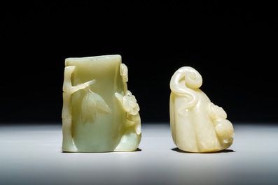 A Chinese celadon jade brush pot and a group with a boy on a lotus flower, 19/20th C.