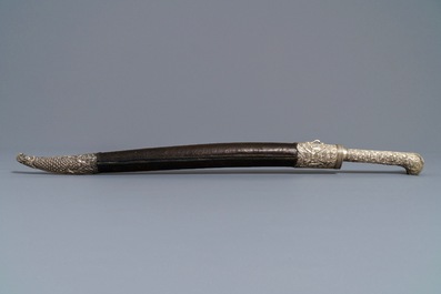 An Ottoman silver-mounted Damascus steel 'yatagan' sword in its leather sheath, Turkey, 19th C.