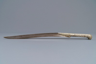 An Ottoman silver-mounted Damascus steel 'yatagan' sword in its leather sheath, Turkey, 19th C.