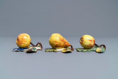 Two polychrome Dutch Delft models of apples and one of a pear, 18th C.