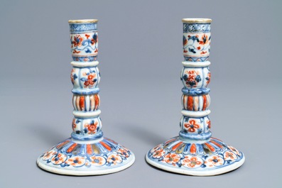 A pair of Chinese Imari-style candlesticks after European silver models, Kangxi