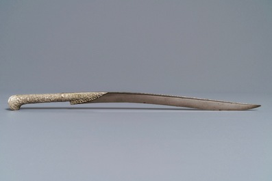 An Ottoman silver-mounted Damascus steel 'yatagan' sword in its leather sheath, Turkey, 19th C.