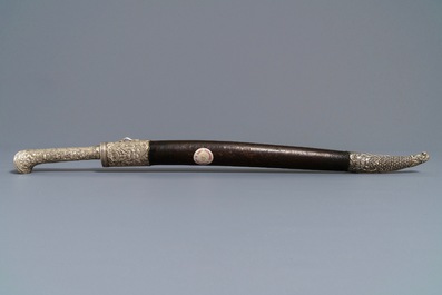 An Ottoman silver-mounted Damascus steel 'yatagan' sword in its leather sheath, Turkey, 19th C.