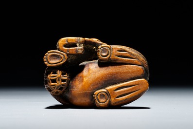 A Japanese carved wood netsuke of a shishi with cub, Edo, 18/19th C.