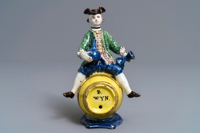 A polychrome Dutch Delft figure of a man on a barrel, 18th C.