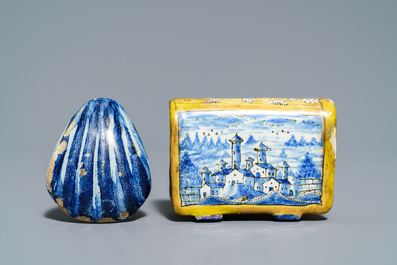 A manganese Dutch Delft miniature stove, a blue and white shell and a French book-shaped handwarmer, 18th C.