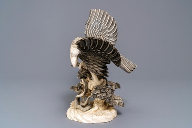 A Chinese carved ivory model of an eagle with a snake, ca. 1930