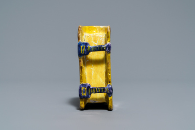 A manganese Dutch Delft miniature stove, a blue and white shell and a French book-shaped handwarmer, 18th C.