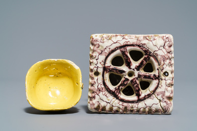 A manganese Dutch Delft miniature stove, a blue and white shell and a French book-shaped handwarmer, 18th C.