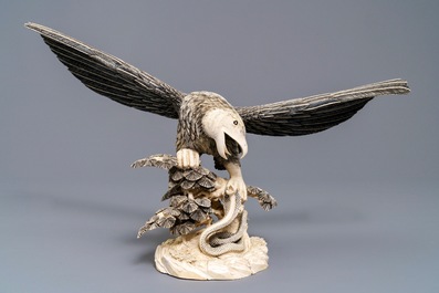 A Chinese carved ivory model of an eagle with a snake, ca. 1930