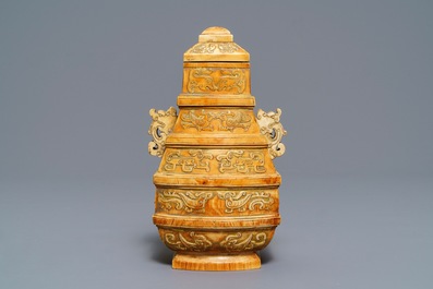A Chinese archaistic ivory vase and cover on wooden stand, ca. 1900