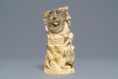 A Chinese ivory group of a sage with a tiger, 19/20th C.