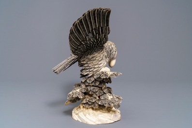 A Chinese carved ivory model of an eagle with a snake, ca. 1930