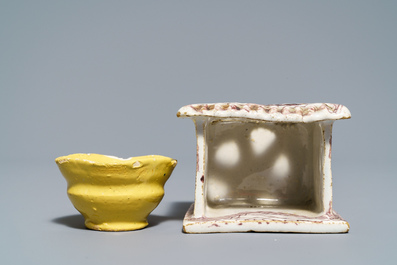 A manganese Dutch Delft miniature stove, a blue and white shell and a French book-shaped handwarmer, 18th C.