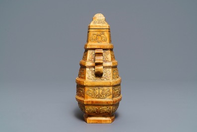 A Chinese archaistic ivory vase and cover on wooden stand, ca. 1900