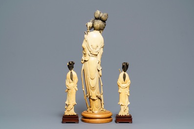One large and a pair of smaller Chinese ivory figures of court ladies, ca. 1900