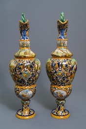 A pair of massive Italian maiolica ewers with figures in landscapes, 19th C.