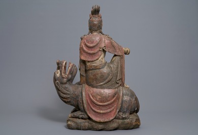 A Chinese polychrome wood group of Guanyin on a dragon, 18th C.