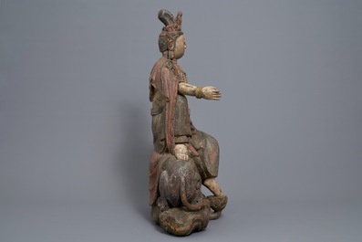 A Chinese polychrome wood group of Guanyin on a dragon, 18th C.