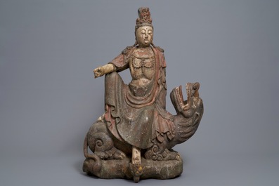A Chinese polychrome wood group of Guanyin on a dragon, 18th C.